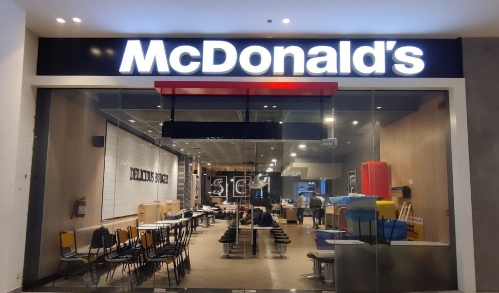 The picture is of Mcdonald's restaurant. There is Mcdonalds written in white and you can get McDonald's 2 for $4 Deal | Is It Still Available In 2024