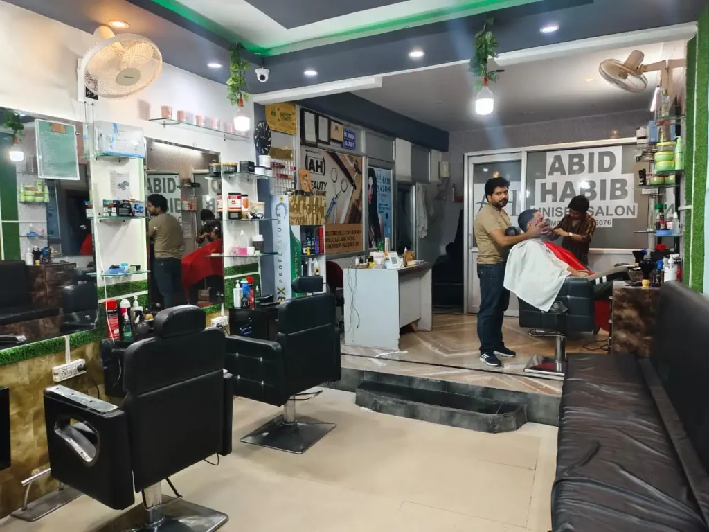 The hairdresser is shaving someone in one of the top hair saloon in Jammu