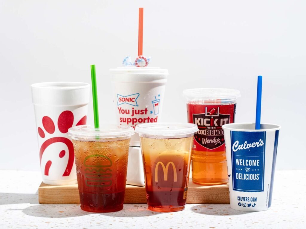 Five cups of iced tea from different fast food restaurants: Chick-fil-A, Sonic, McDonald's, Wendy's, and Culver's. The Sonic cup features a patriotic design and the Wendy's cup has a football-themed design. Guide to Sonic Route 44